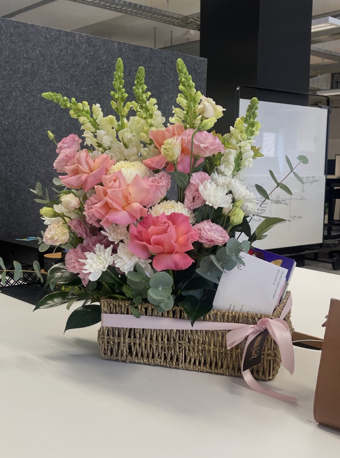 Flowers and a note left on a team member desk